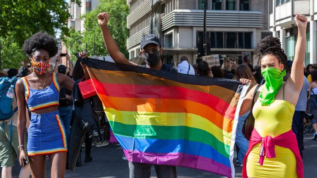 Marchers with a Pride flag