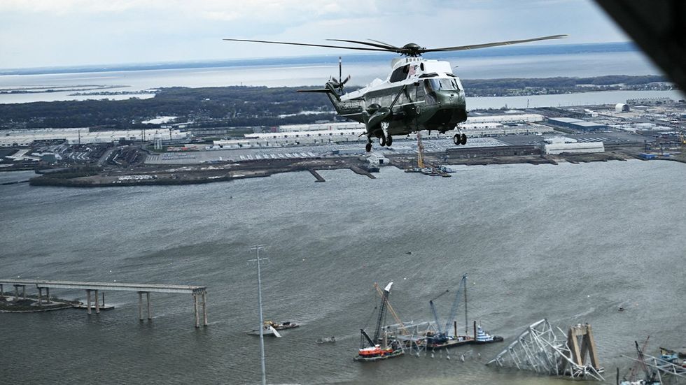 Marine One with US President Joe Biden onboard over collapsed Francis Scott Key Bridge in Baltimore, Maryland