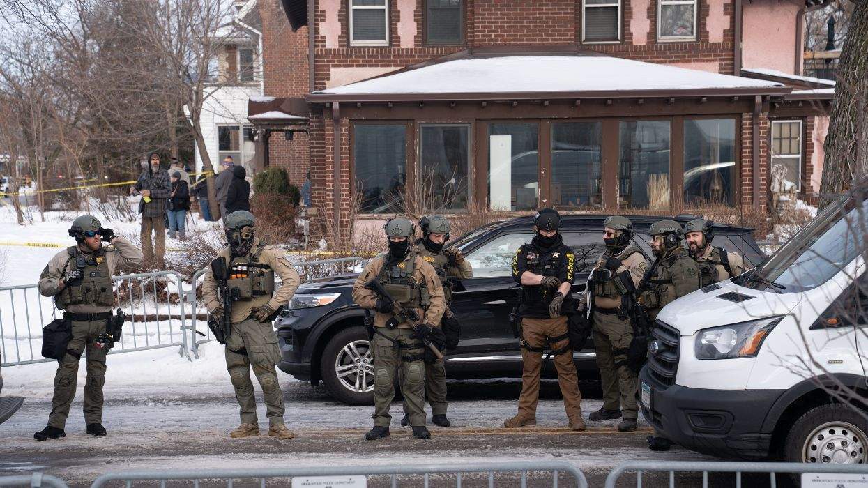 Masked, armed federal agents stand in the streets of Minneapolis