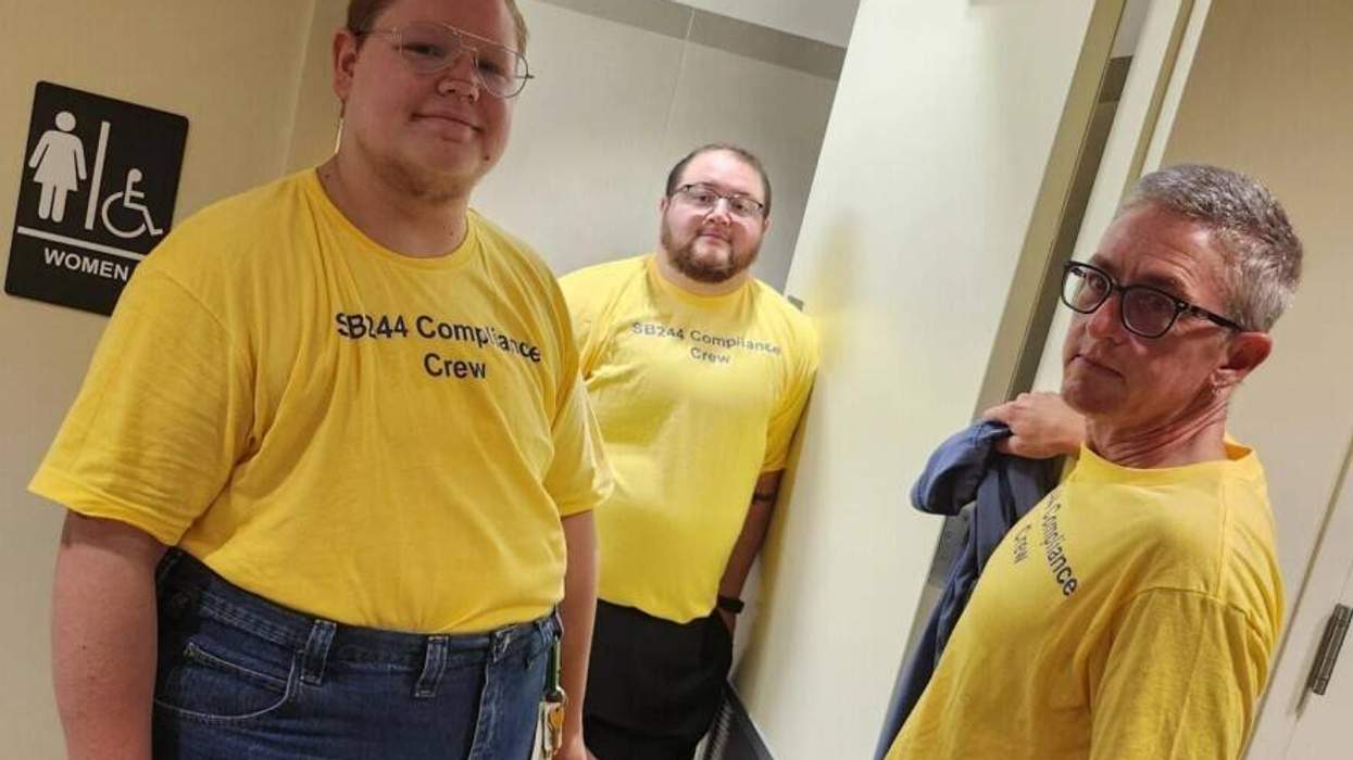 members of the compliance crew protesting outside of a Kansas bathroom