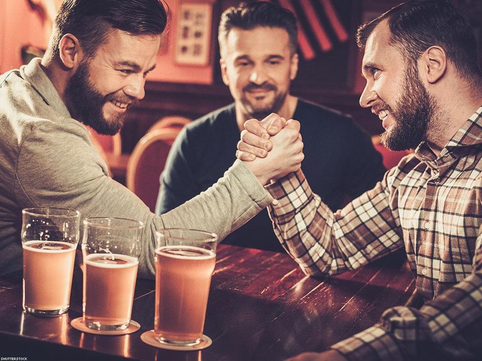 men arm wrestling in a bar