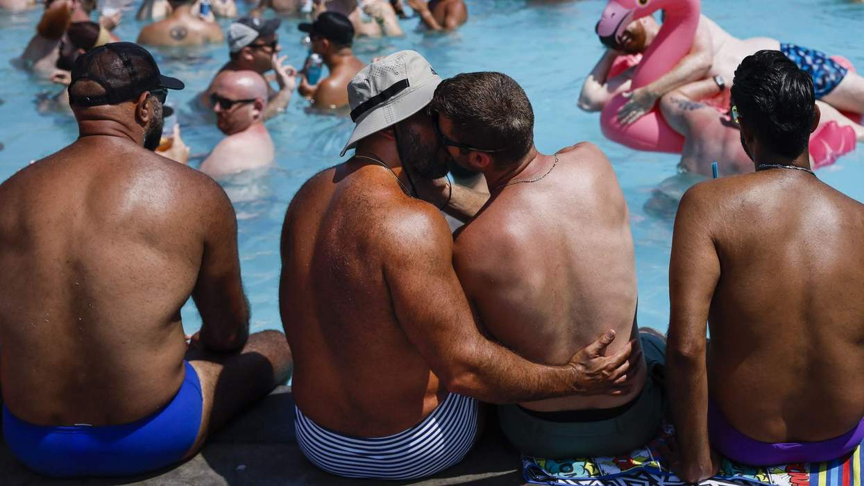 Men embrace at the Provincetown Inn at the start of Bear Week 2024.