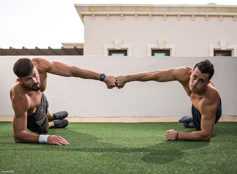 men exercising giving fist bump