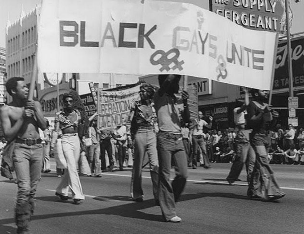 Men hold a "Black Gays Unite" banner at the Los Angeles Christopher Street West pride parade, 1975