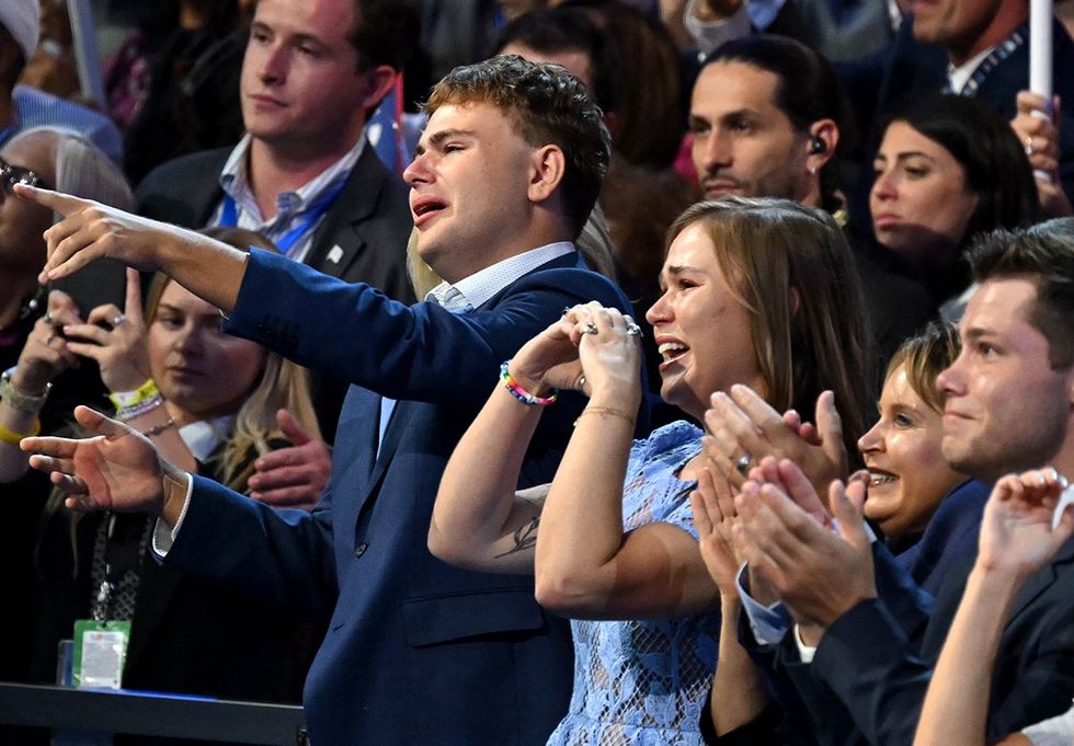 Minnesota Governor 024 Democratic vice presidential candidate Tim Walz son Gus pointing daughter Hope hearthands react as he speaks on the third day of the Democratic National Convention DNC at the United Center in Chicago Illinois