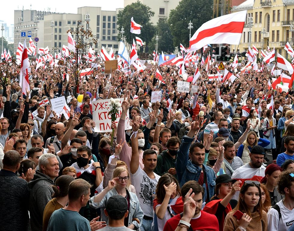 Minsk Belarus 2020 Peaceful protests on Niezalie\u017enasci street in Minsk about the latest Belarus election result flood of people with flags marching towards Independence Avenue