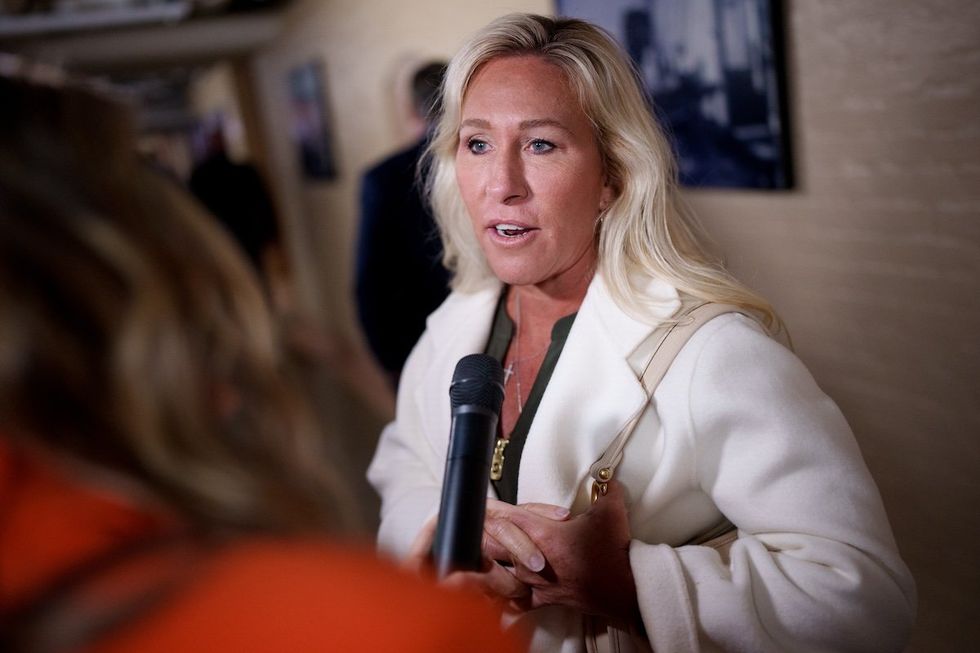 MTG speaking with a reporter with a microphone