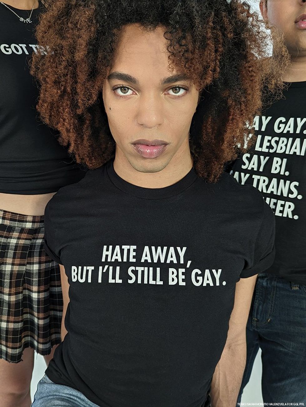 Myles "Mother Telfar" Mugler wears a t-shirt that reads, "Hate away, but I'll still be gay."