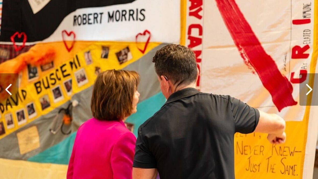 Nancy Pelosi and John Casey looking at AIDS Memorial Quilt