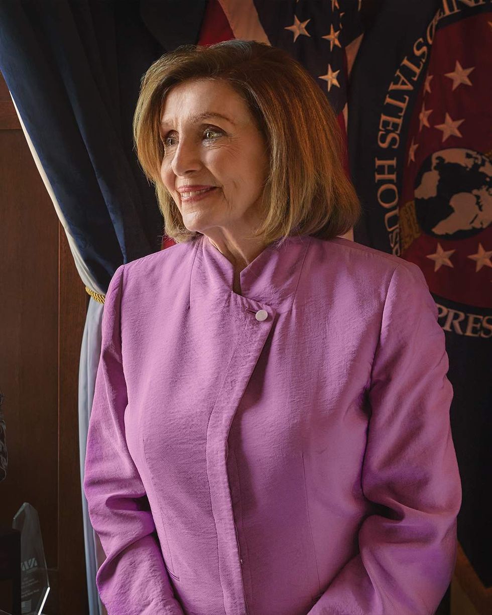 Nancy Pelosi in a pink blouse, photographed for The Advocate.