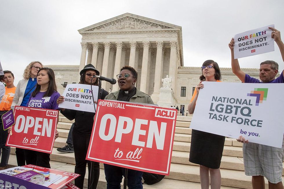 Naomi Washington Leapheart, center, the faith work director for the National LGBTQ Task Force, addresses activists in front of the Supreme Court