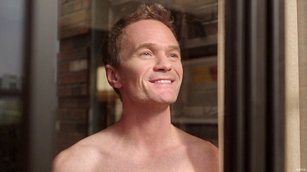 Neil Patrick Harris, shirtless and looking out a window