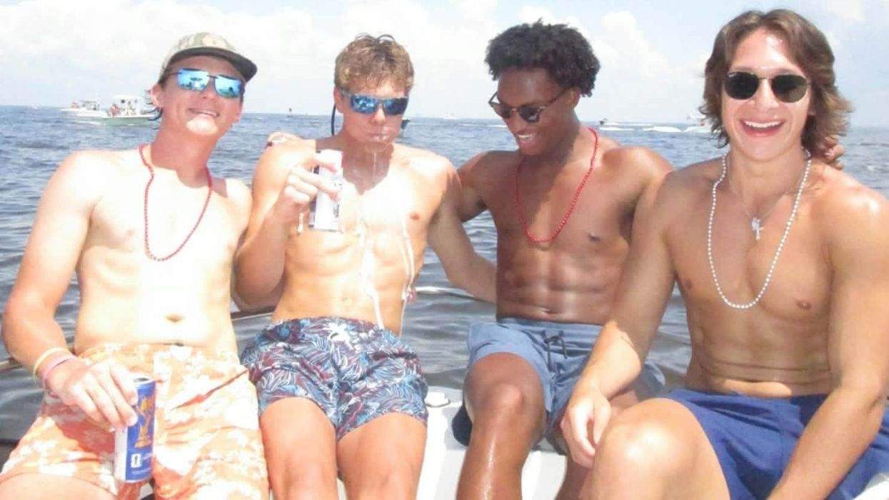 nolan wells with friends on a boat