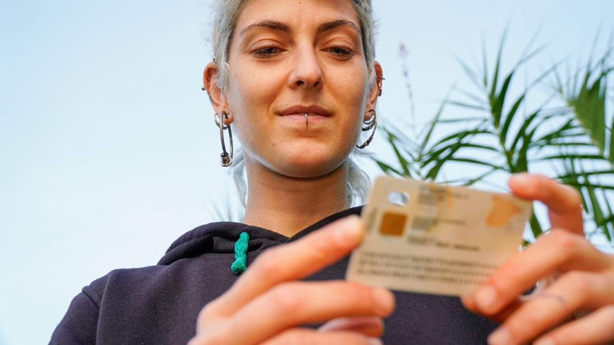 Nonbinary person holds driver's license