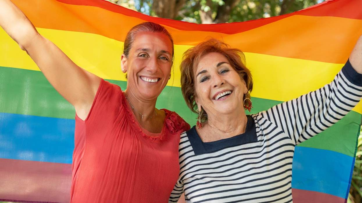 Older lesbian couple with Pride flag