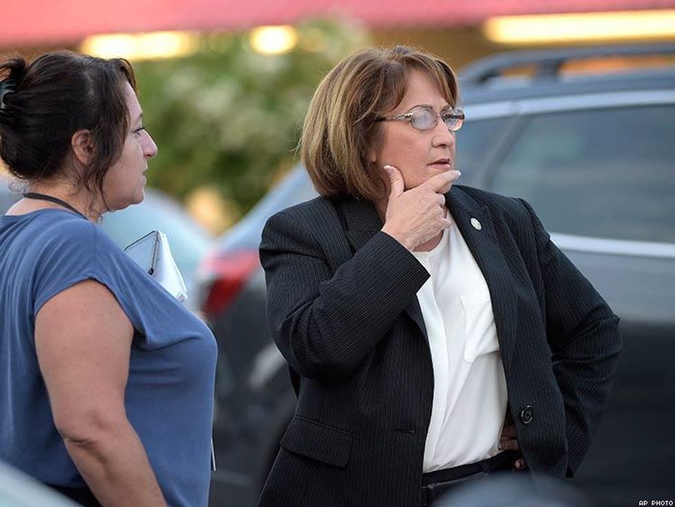 Orange County Mayor Teresa Jacobs, right, is briefed after arriving to the scene