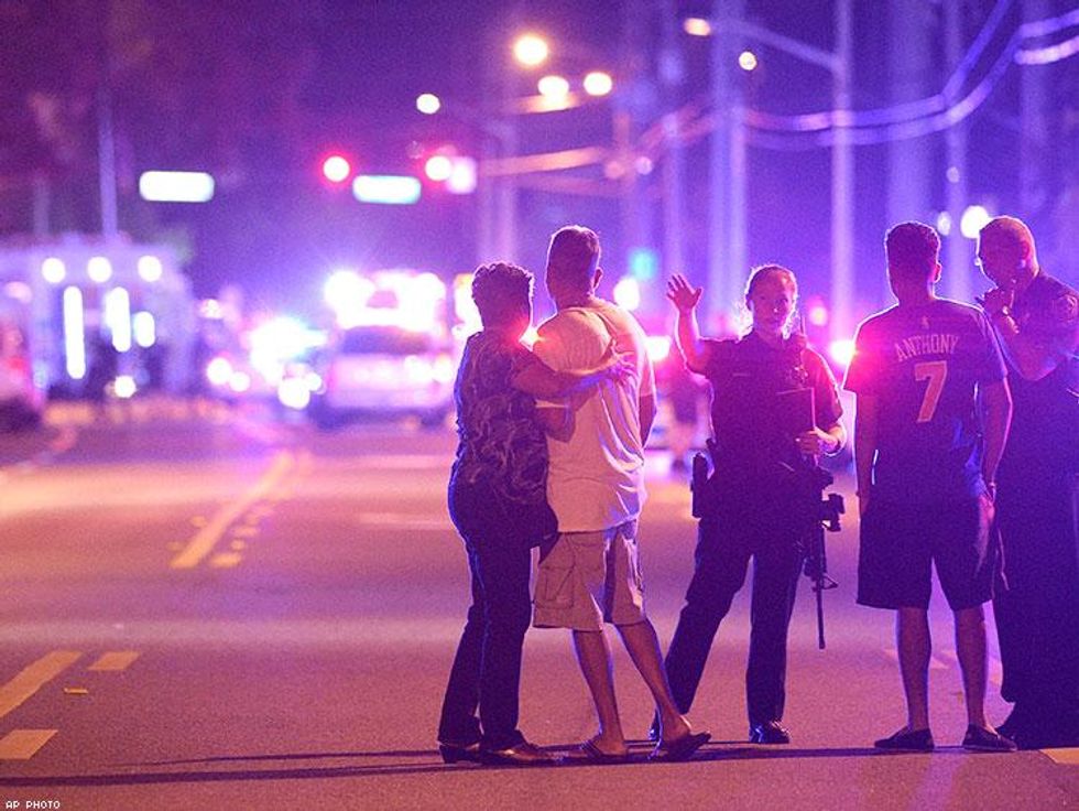 Orlando Police officers direct family members away from a fatal shooting at Pulse Orlando