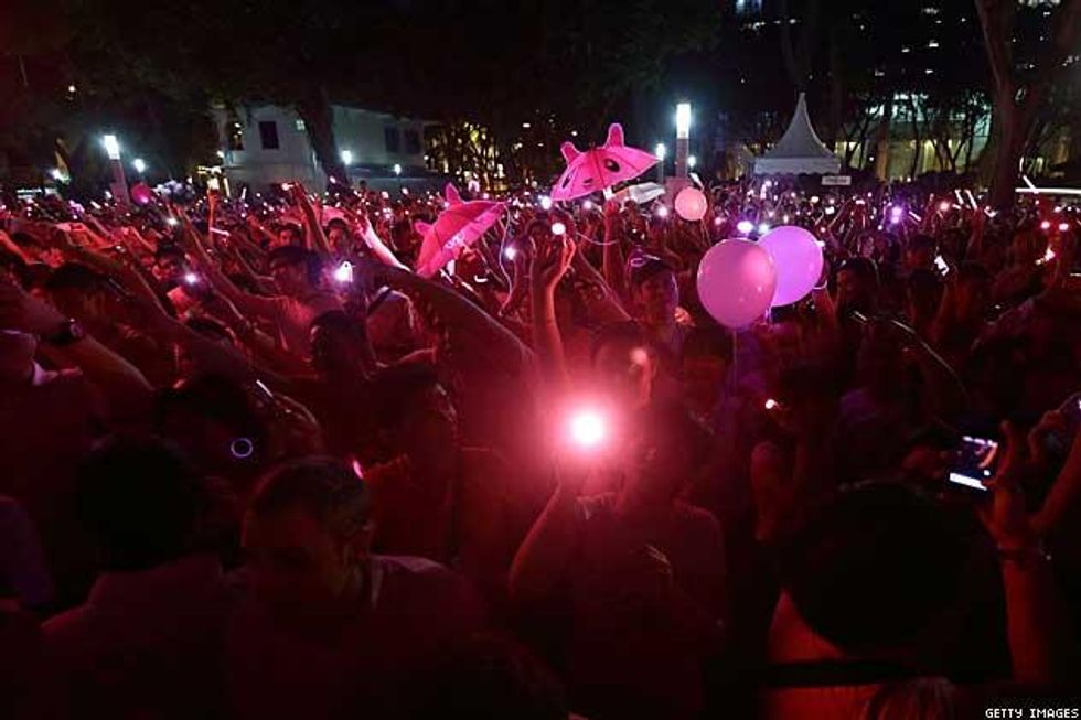 Participants-gather-to-form-a-glowing-human-pink-dot-during-the-night-pink-dotx633