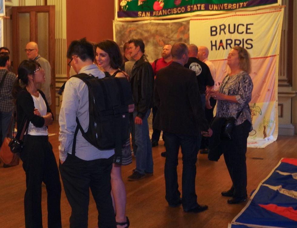 Party guests in the aids quilt room