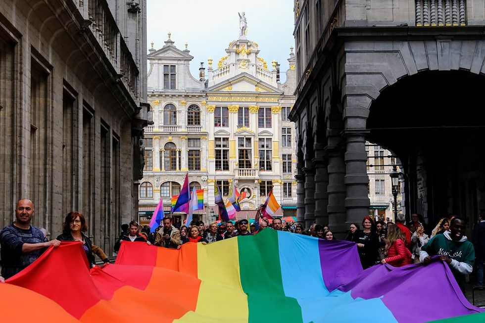 People carry a large rainbow flag at Belgian LGBTQIA Pride Brussels 2023