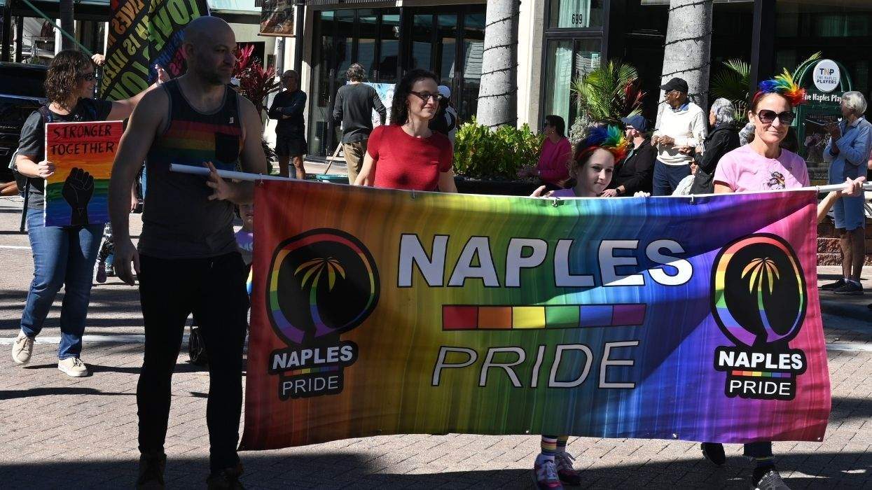 people during pride parade with naples pride sign