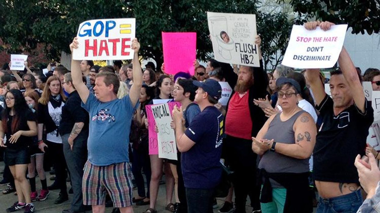 People protest outside the North Carolina Executive Mansion in Raleigh, N.C., Thursday, March 24, 2016. North Carolina legislators decided to rein in local governments by approving a bill Wednesday that prevents cities and counties from passing their own