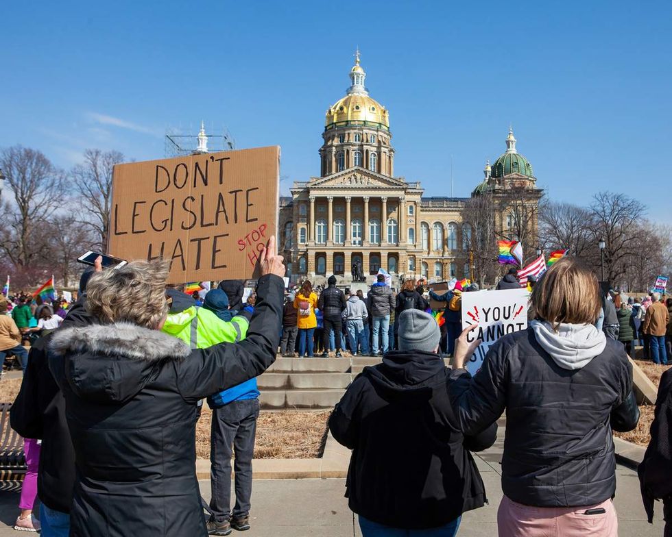 People protesting anti-LGBTQ bills outside the Iowa State Capitol in Des Moines