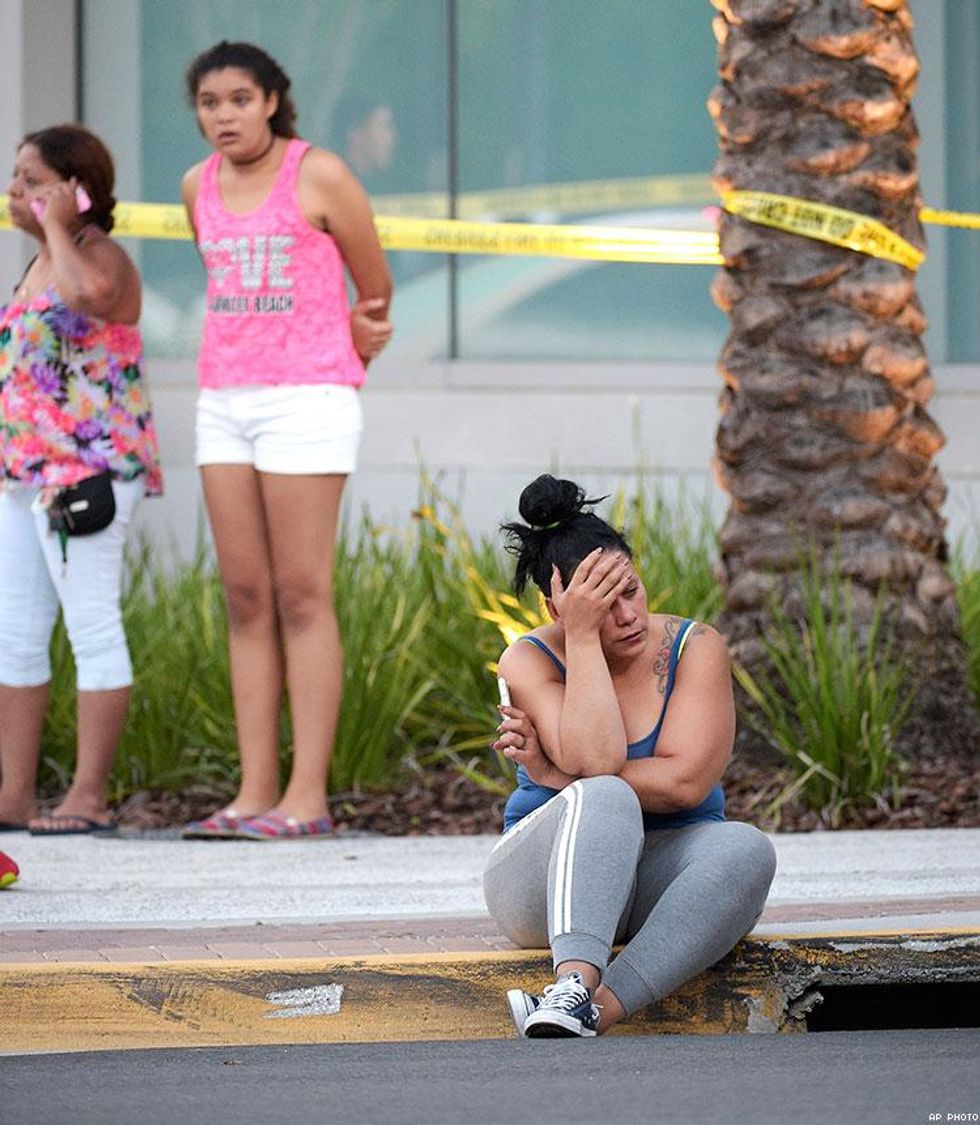 People wait outside the emergency entrance of the Orlando Regional Medical Center hospital after THE shooting involving multiple fatalities at Pulse Orlando.
