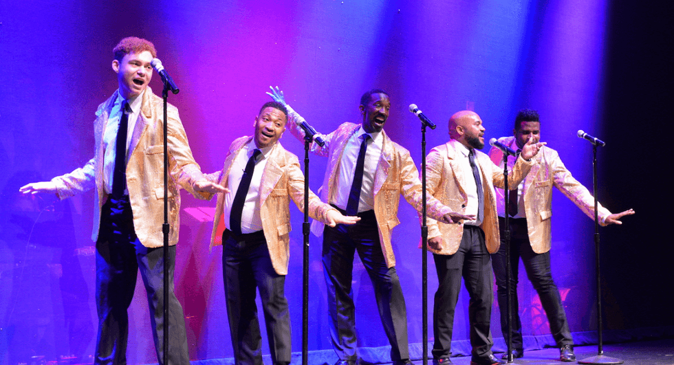 Performers from the Gay Men\u2019s Chorus of Washington, DC sing and dance on stage