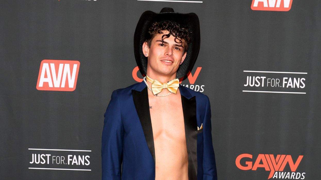 Person in a cowboy hat and bowtie on an AVN event red carpet.