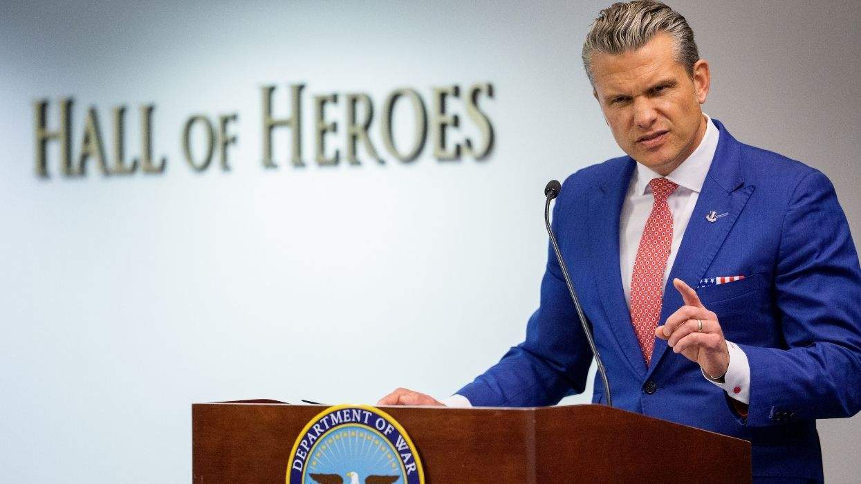 pete hegseth speaking in front of a wall that says halls of heroes