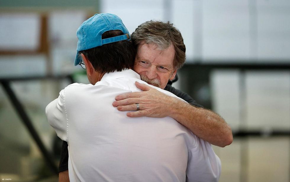 Phillips, owner of Masterpiece Cakeshop, is hugged after the ruling.