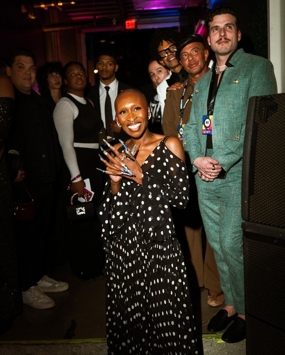 photo gallery queer photographer Roland Fitz Out100 2024 party pics crowd watching show focus on Cynthia Erivo