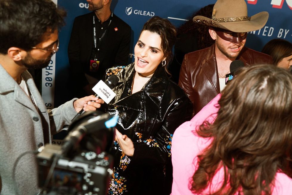 photo gallery queer photographer Roland Fitz Out100 2024 party pics Nava Mau and Oliver Peck being interviewed during arrivals