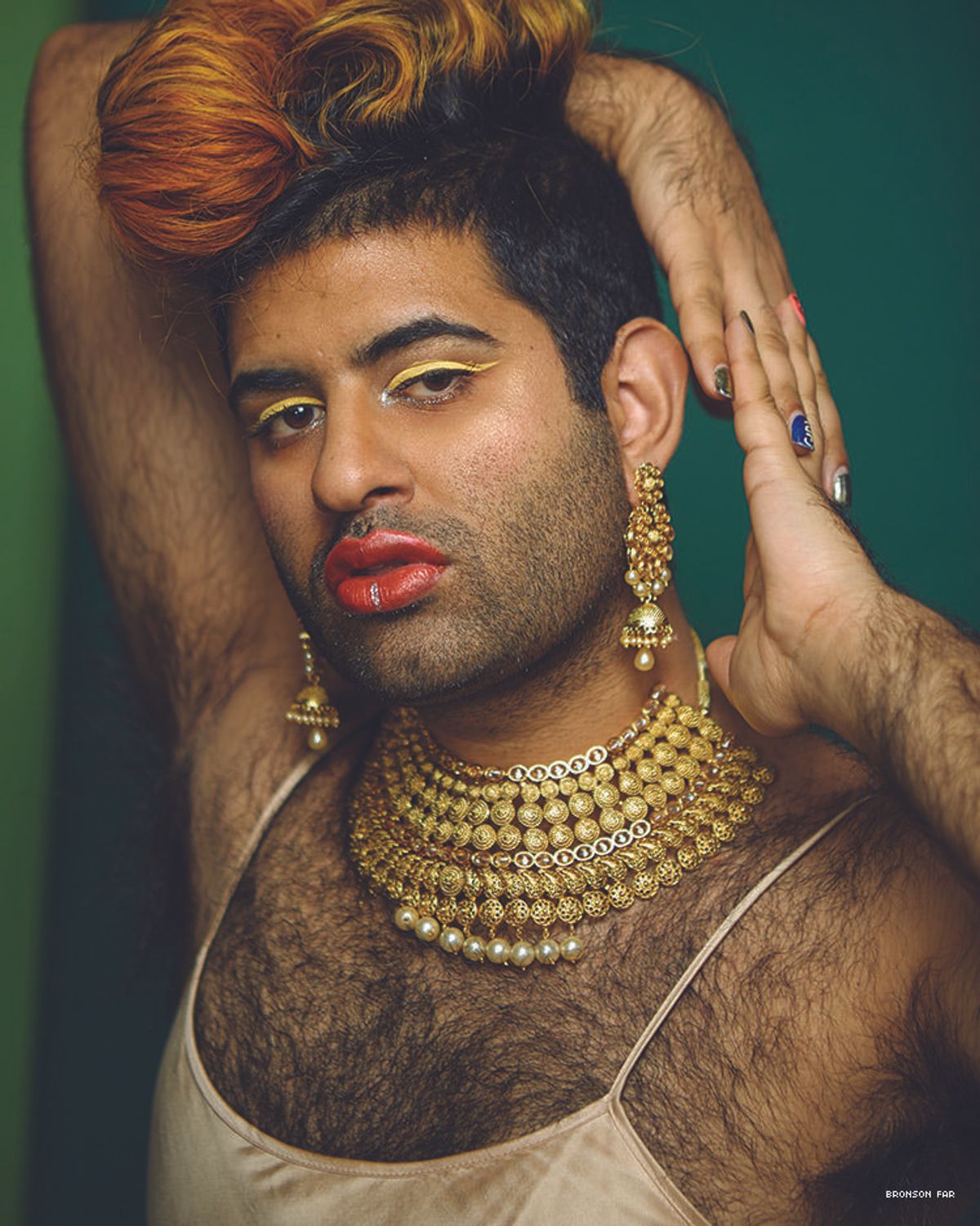 Photo of genderqueer Indian-American artist Alok Vaid-Menon in a gold slip dress