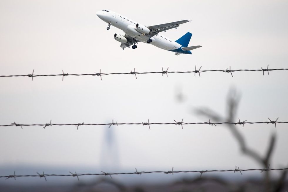 Plane flying behind barbed wire