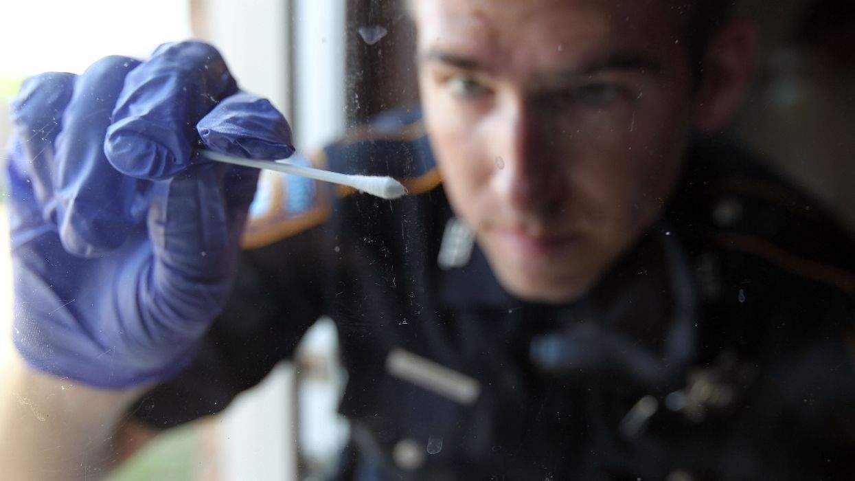 police officer swabbing dna