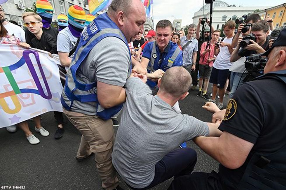 Police officers detain a protester during the annual Gay Pride parade in Kiev,