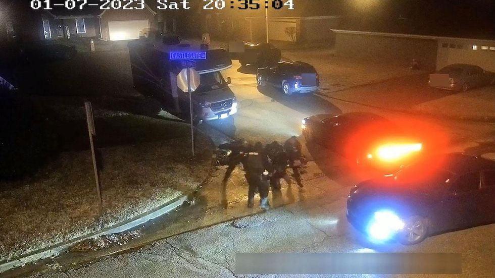 Police video shows officers gathered around Tyre Nichols at night with police cars stopped around them