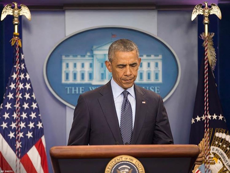 President Barack Obama pauses as he speaks about the massacre.