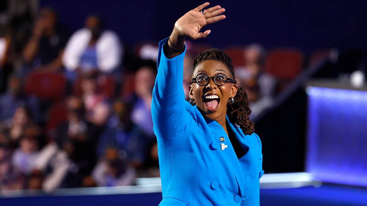 President of the Human Rights Campaign Kelley Robinson DNC 2024 stage waving to crowd