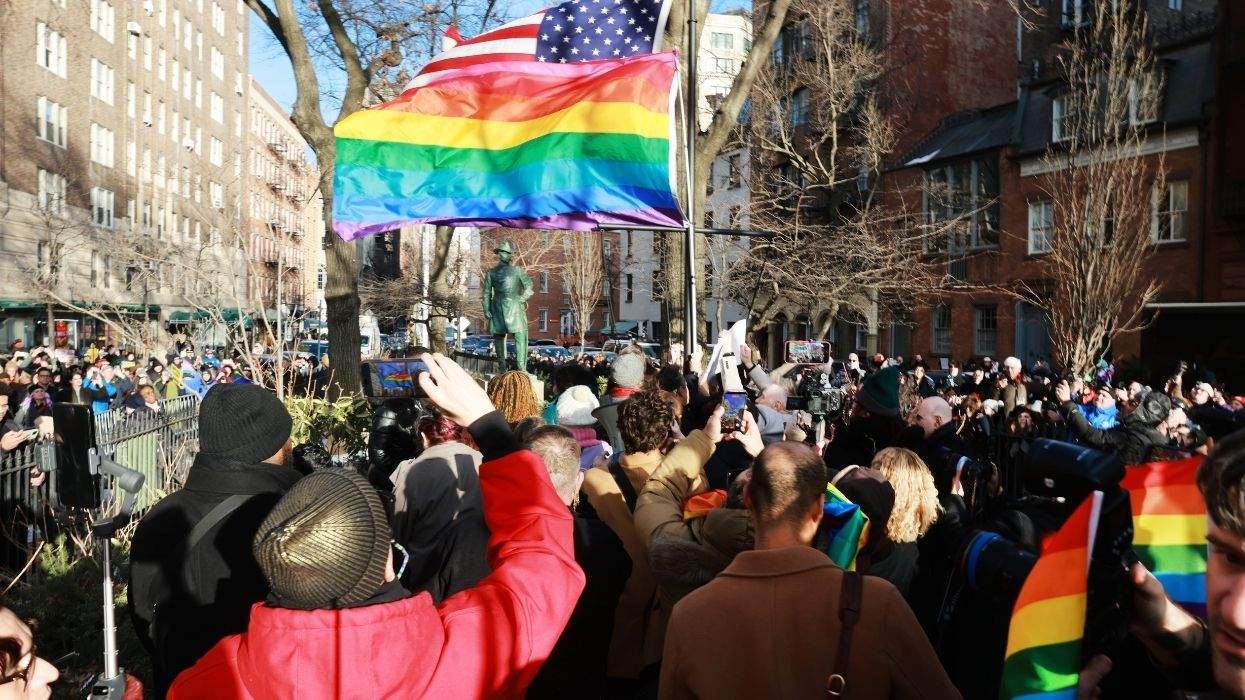 pride flag and a crowd of people at the stonewall national monument