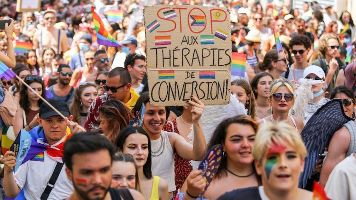 Pride march in France with a sign against conversion therapy