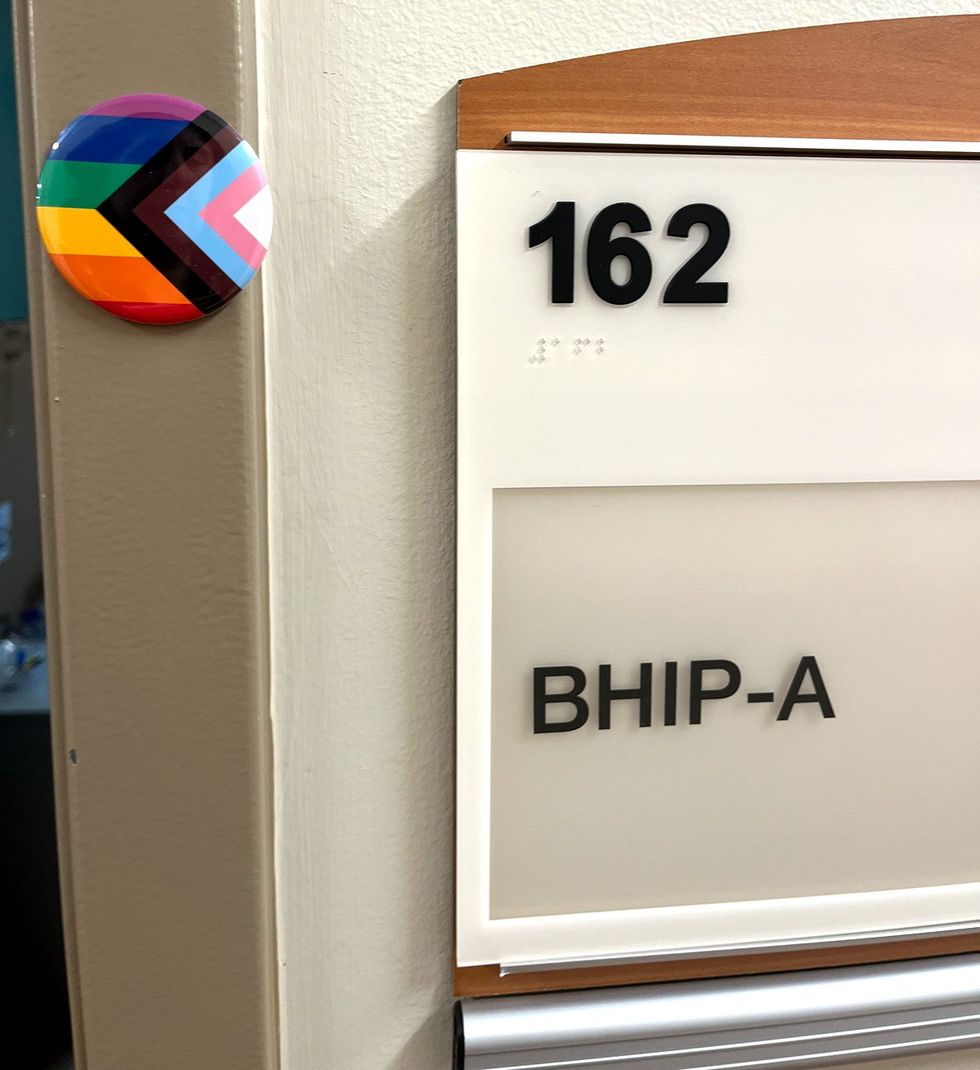 progress pride flag button on office door
