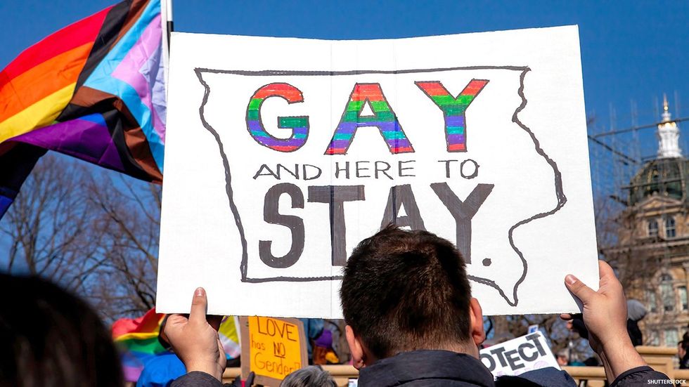 Protest with "gay and here to stay" sign in Iowa