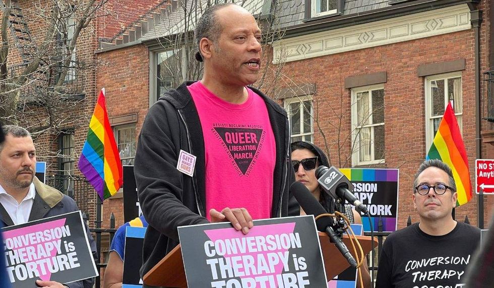 protesters holding conversion therapy is torture signs