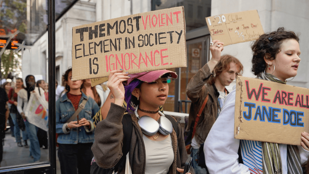 Protesters march through London's Leicester Square holding signs reading “The most violent element in society is ignorance” and “We are all Jane Doe” during a demonstration supporting a former Cornell University student.
