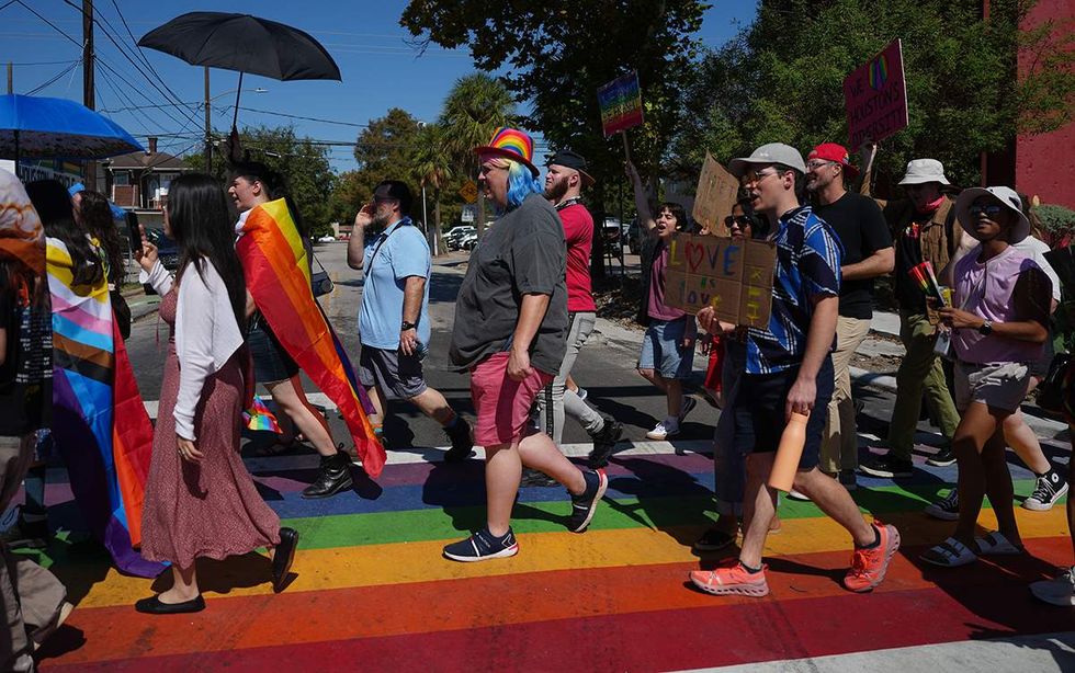 Protesters marching across rainbow crosswalk Houston Texas