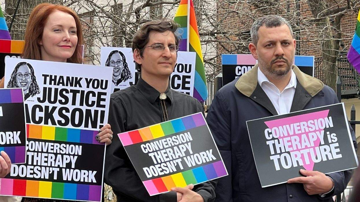 protestrs at stonewall national monument holding anti-conversion therapy signs