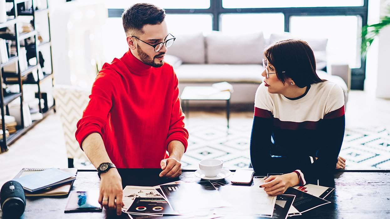 queer designers at work discussing files on the table